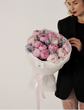 Light pink peonies with delphinium
