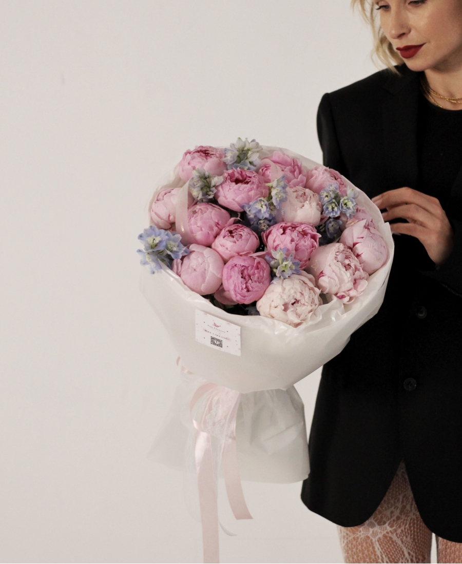 Light pink peonies with delphinium